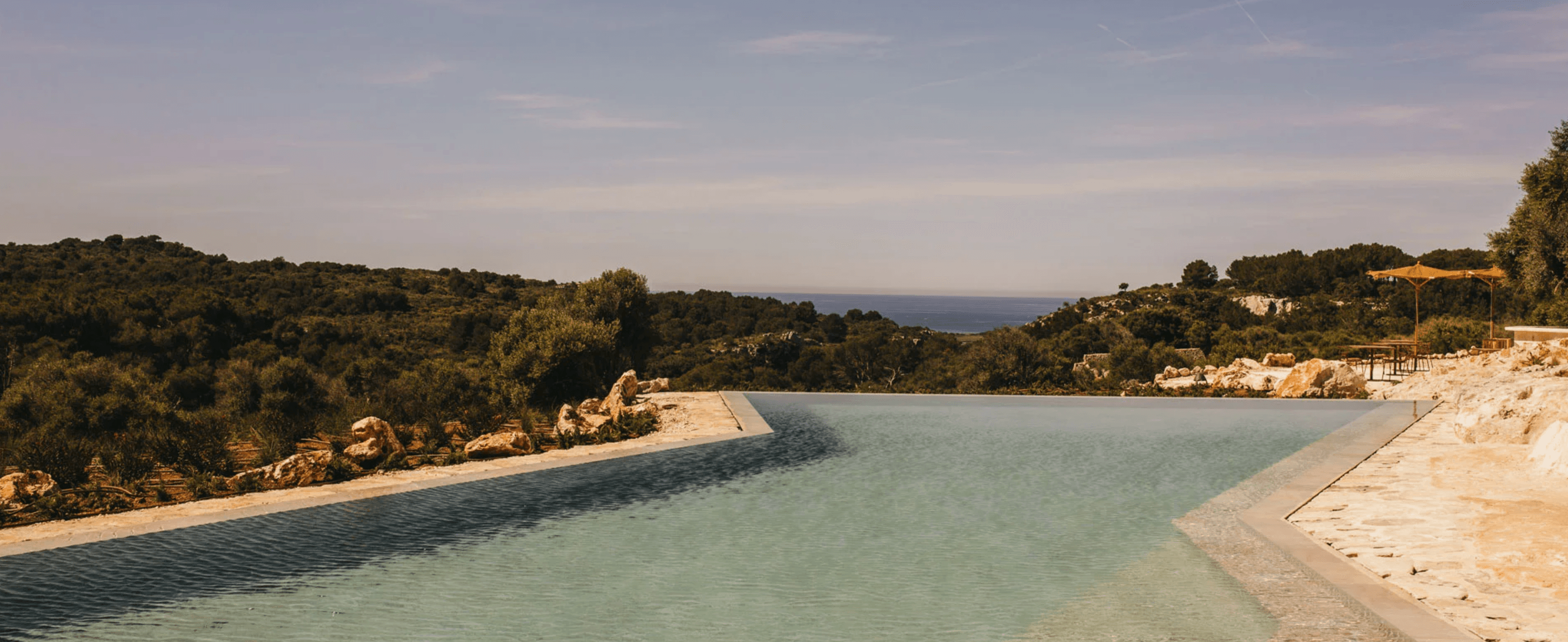 Son Blanc Farmhouse surrounded by gardens, olive groves and Mediterranean countryside in Menorca, Spain.