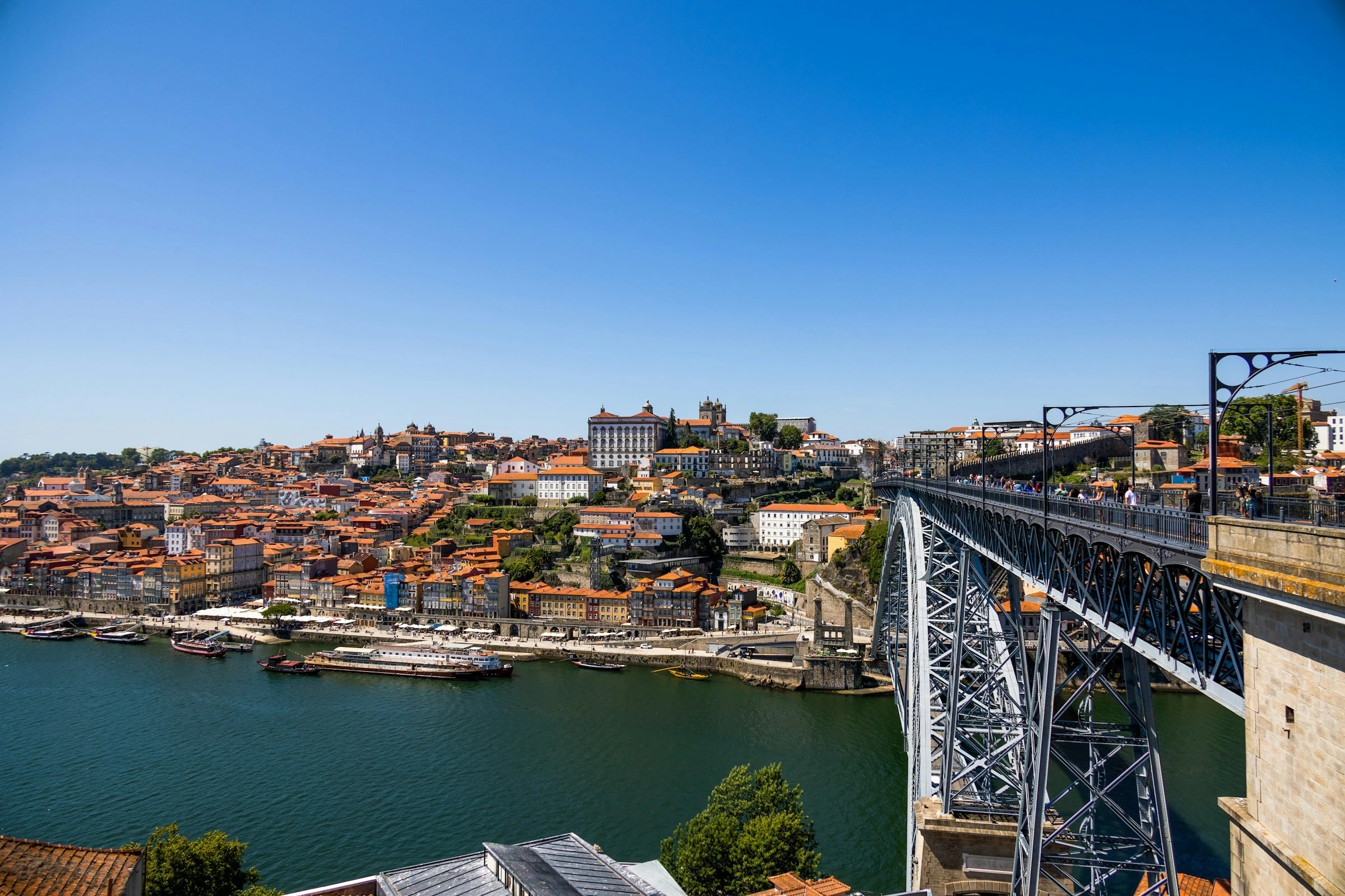 Looking across the Douro to Porto from Vila Nova de Gaia. The port lodges, Real Companhia Velha among them, are on this side; you can walk over on the Dom Luís I bridge. Photo: Gustavo Soares / Unsplash