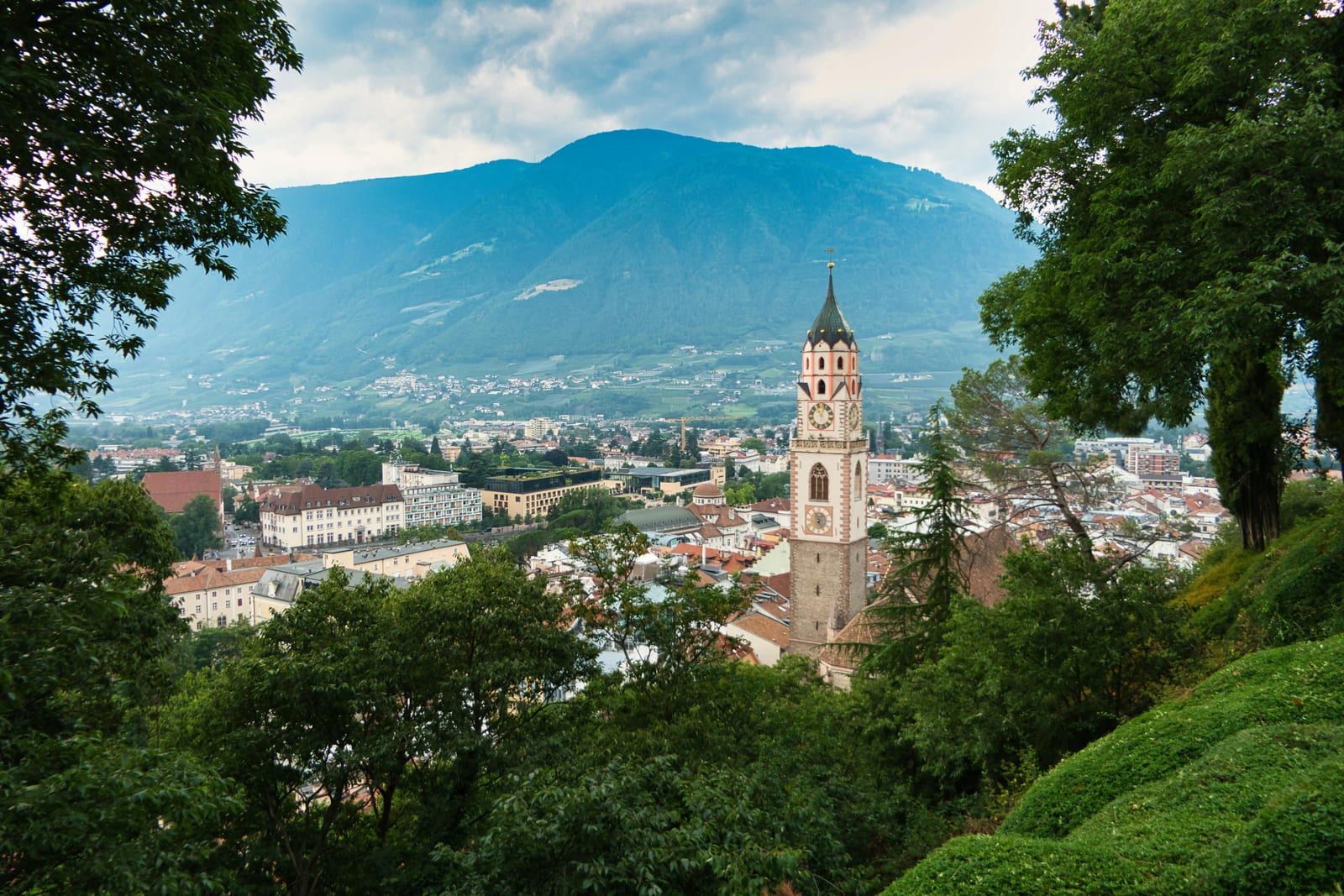 Merano old town with its church tower beneath the surrounding mountains