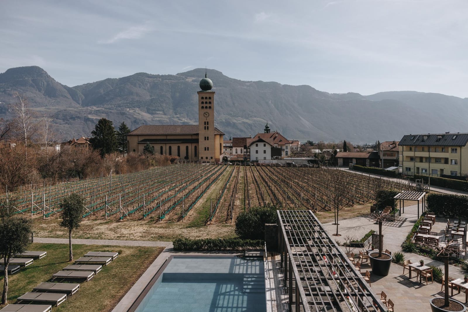 Hotel Schwarzschmied — pool and pavilion set among the vineyards of Lana