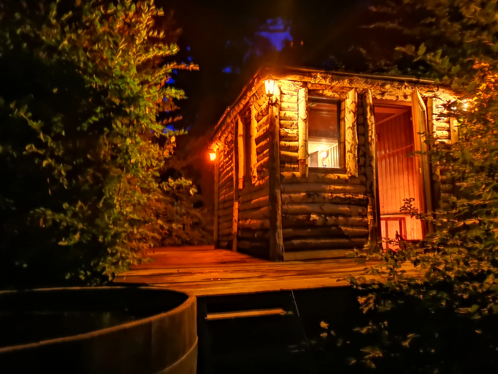 The forest sauna, built of timber planks, lit up at night. Photo: Pauline Roy Chowdhury / Zabola Estate